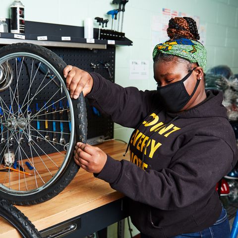 teen repairing bikes